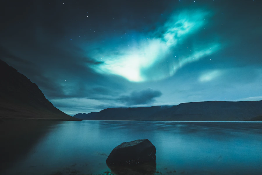 Aurora borealis dancing over a dramatic Iceland landscape