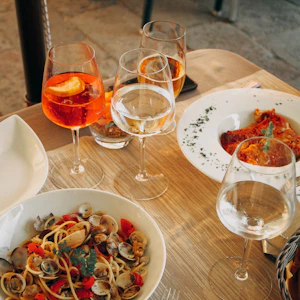 Wine glasses and food on table in Italy