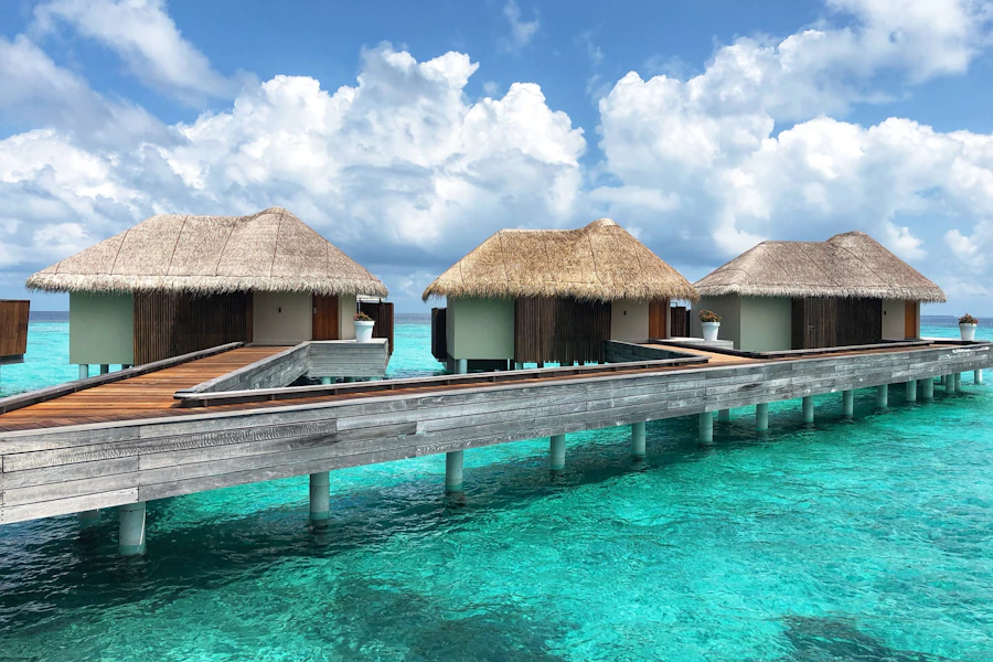Overwater bungalows over crystal turquoise water in the Maldives